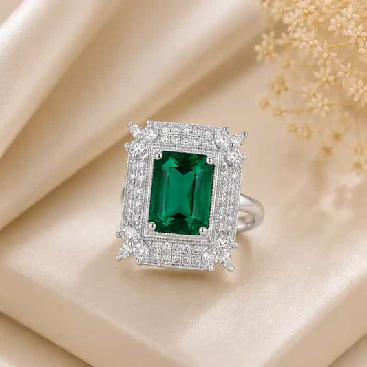 Silver-tone Royale Halo Statement Ring featuring a large emerald-cut aqua green crystal center stone framed by a double halo of sparkling zircon stones and vintage floral accents.